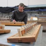 Close up view of small releathered pneumatics of pipe organ wind chest